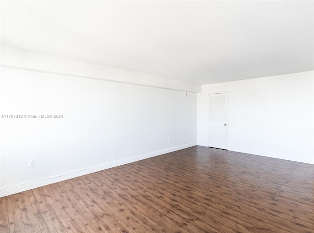 spare room with dark hardwood / wood-style flooring