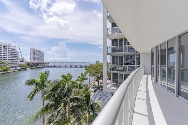 balcony with a view of city and a water view