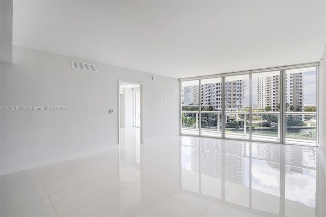 495 Brickell Ave Unit Bay407, Miami, FL 33131 - unfurnished room featuring a wall of windows, light tile patterned floors, and a city view