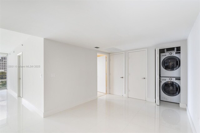 495 Brickell Ave Unit Bay407, Miami, FL 33131 - laundry room with estacked washer and dryer, baseboards, and light tile patterned floors