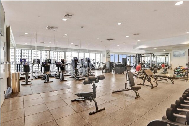 gym featuring a city view, visible vents, and recessed lighting