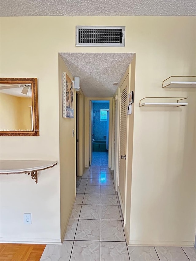 corridor with a textured ceiling