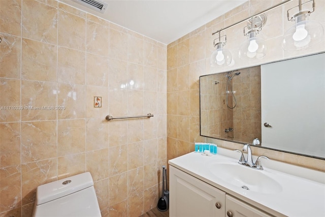 bathroom with toilet, visible vents, tile walls, and vanity