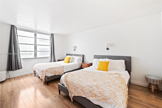 bedroom with wood finished floors and baseboards