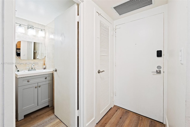 interior space featuring a sink, visible vents, and light wood-style floors