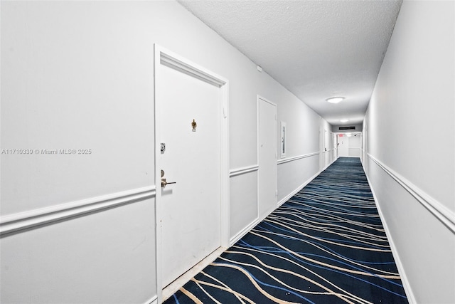 corridor with a textured ceiling