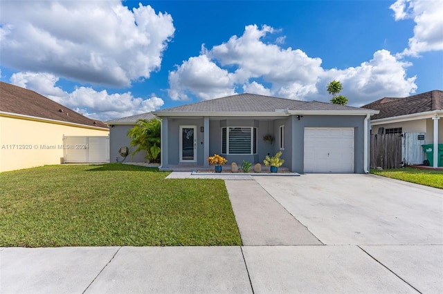 single story home with a front lawn, a porch, and a garage