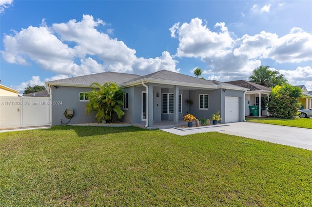 view of front of property with a porch, a front yard, and a garage