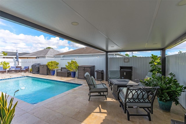 view of pool featuring a patio and grilling area