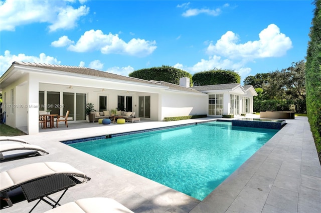 pool with an outdoor hangout area, french doors, an exterior structure, a patio area, and ceiling fan