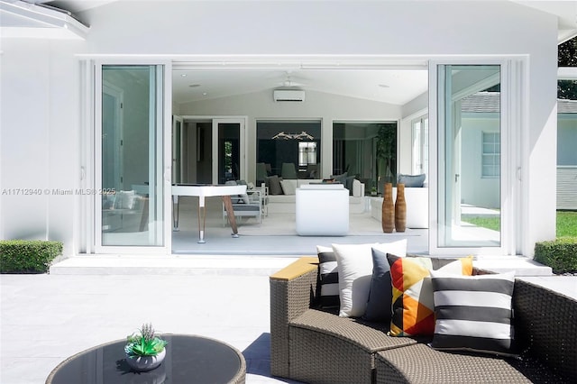 view of patio with a wall mounted air conditioner and outdoor lounge area