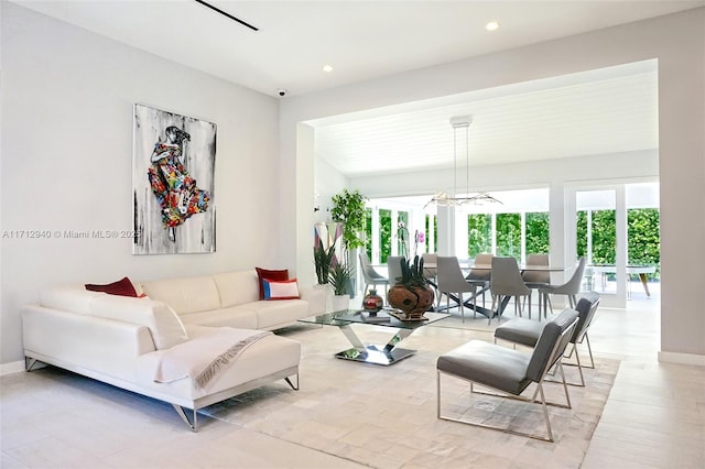 living room with a notable chandelier, baseboards, and recessed lighting