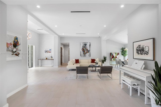 living room with light wood-style flooring, baseboards, lofted ceiling, and recessed lighting