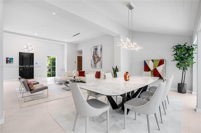 dining space with recessed lighting and a notable chandelier