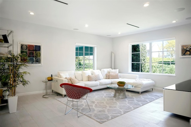 living area featuring recessed lighting and baseboards