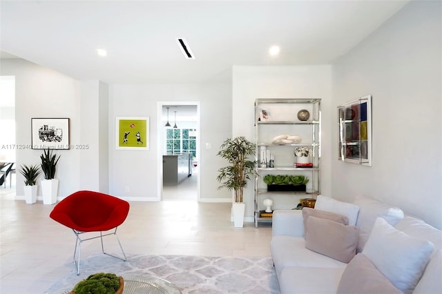 living area featuring visible vents, baseboards, and recessed lighting
