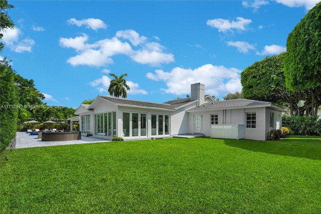 rear view of house with outdoor lounge area, a yard, and a patio area