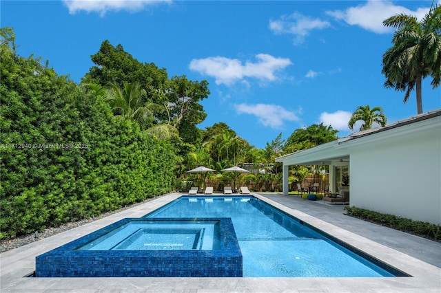 view of pool featuring an in ground hot tub and a patio