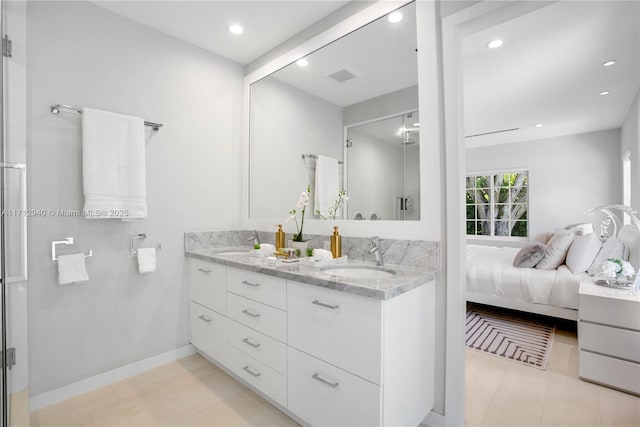bathroom featuring a shower stall, double vanity, a sink, and visible vents