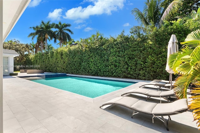 view of swimming pool with a patio area and an in ground hot tub