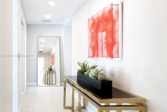 hall with recessed lighting, baseboards, and light tile patterned flooring