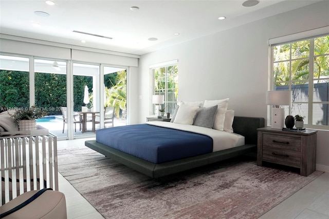 bedroom with recessed lighting and access to outside