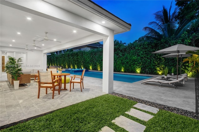 outdoor pool with outdoor dining area, a patio area, and a ceiling fan