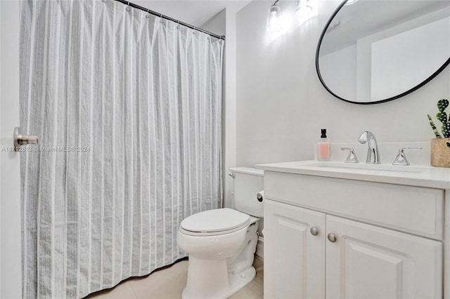 bathroom featuring tile patterned flooring, vanity, and toilet