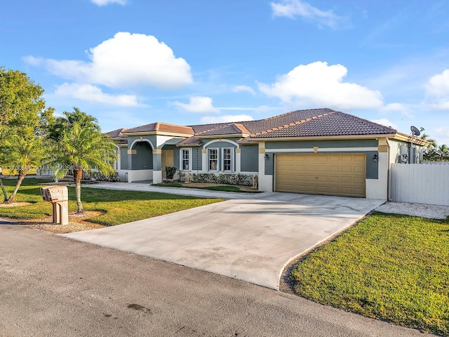 mediterranean / spanish house featuring a front yard and a garage