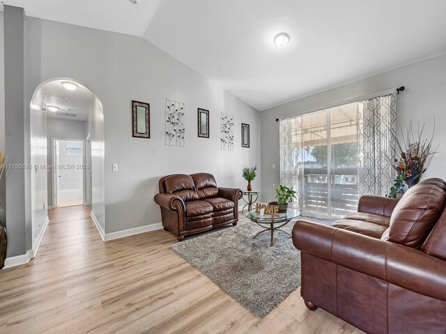 dining room with light hardwood / wood-style floors and lofted ceiling