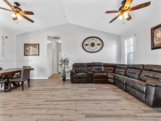 living area with lofted ceiling, visible vents, a ceiling fan, light wood-style floors, and baseboards