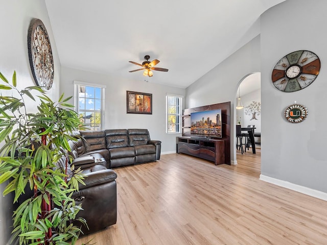 living room with light hardwood / wood-style floors, lofted ceiling, and ceiling fan