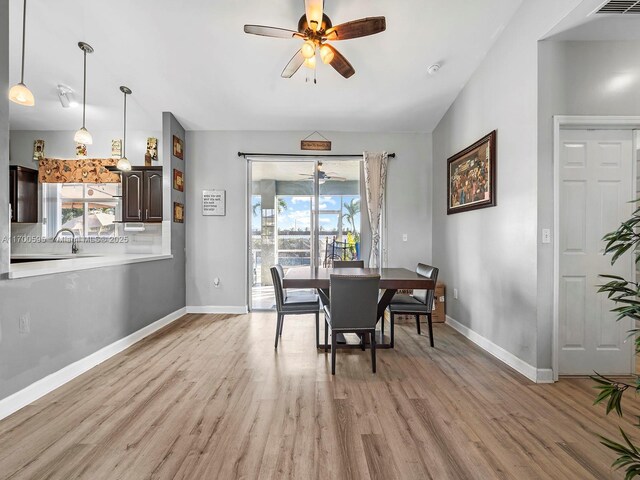 dining room with light wood-type flooring and ceiling fan