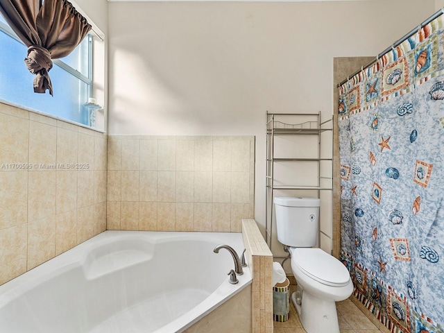 full bath featuring tile patterned flooring, a shower with curtain, a garden tub, and toilet