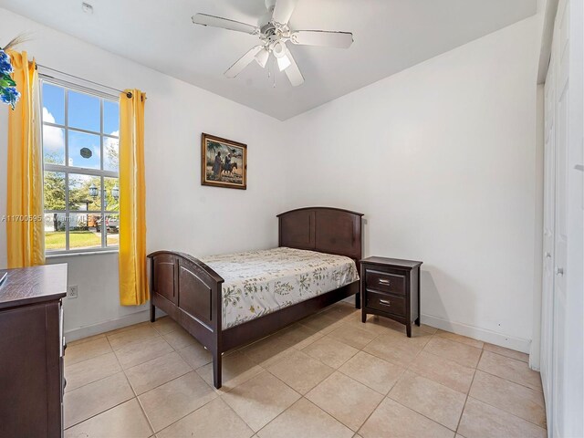 bedroom with ceiling fan and light tile patterned floors