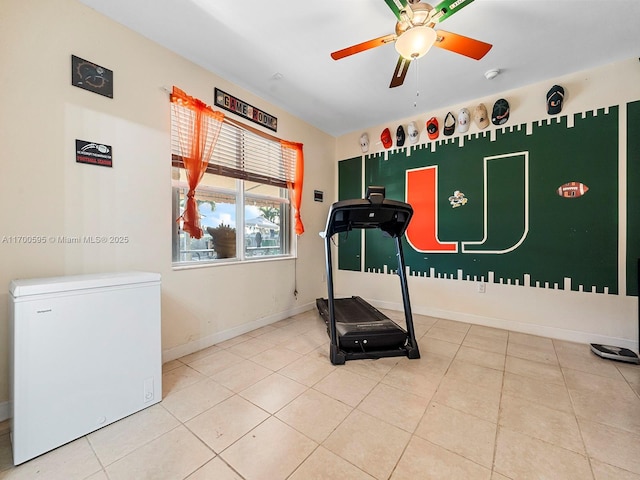 workout room with ceiling fan and light tile patterned floors