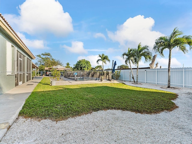 view of yard with fence and a patio