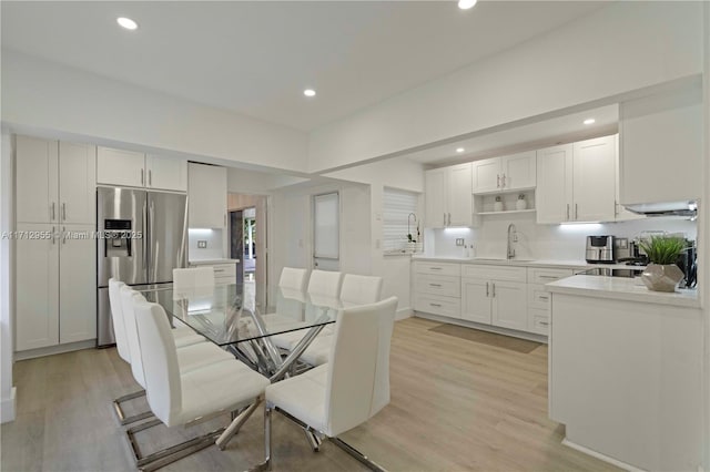 dining room featuring sink and light wood-type flooring