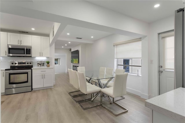 dining room with light hardwood / wood-style flooring