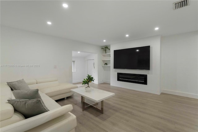 living room with light hardwood / wood-style flooring