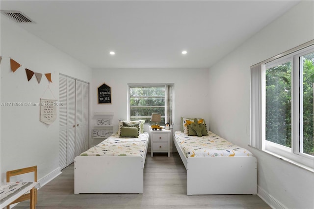 bedroom featuring dark hardwood / wood-style flooring and a closet