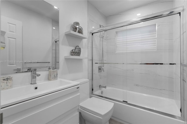 full bathroom with shower / bath combination with glass door, vanity, and toilet