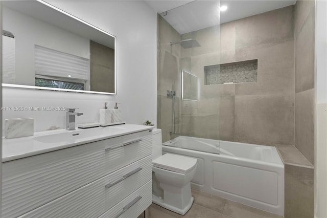 full bathroom with tile patterned flooring, vanity, toilet, and tiled shower / bath