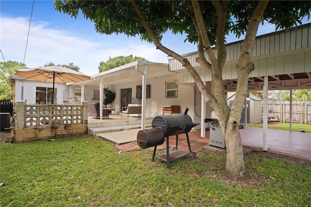 rear view of house featuring a patio area and a yard