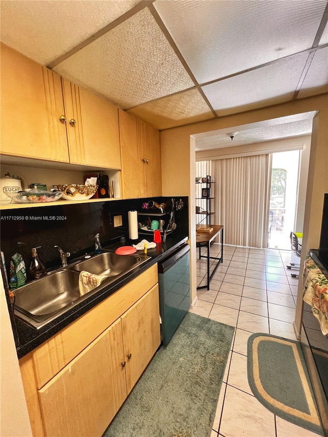 kitchen featuring dishwasher, light tile patterned flooring, and sink