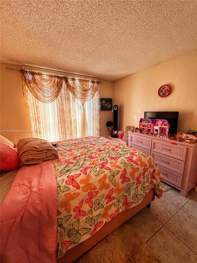 tiled bedroom featuring a textured ceiling