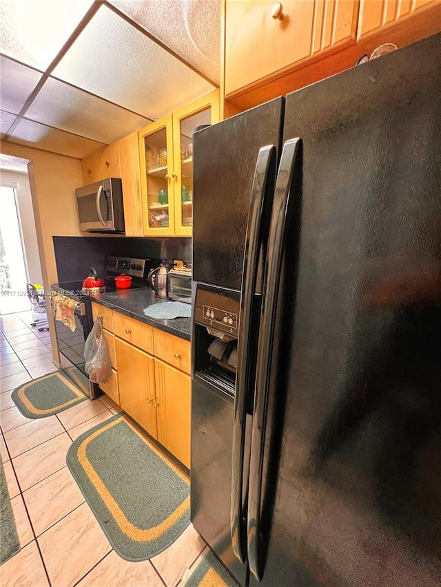 kitchen with black appliances and light tile patterned floors