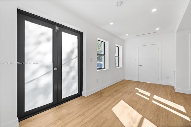 unfurnished room featuring recessed lighting, light wood-type flooring, and baseboards