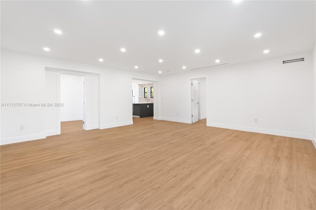 unfurnished living room featuring recessed lighting, visible vents, baseboards, and light wood-style flooring