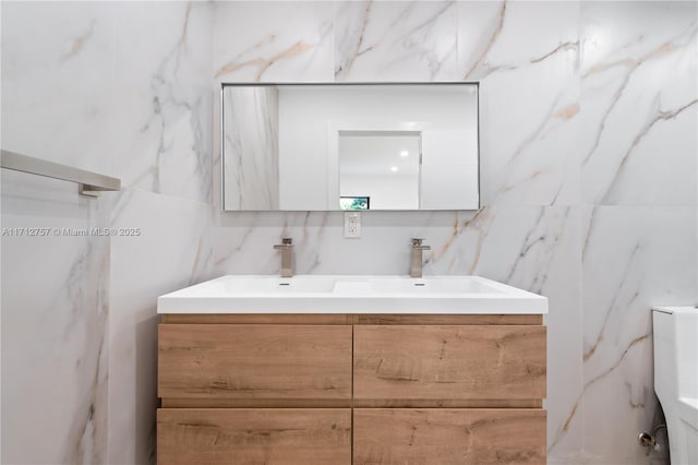 bathroom featuring a sink and double vanity